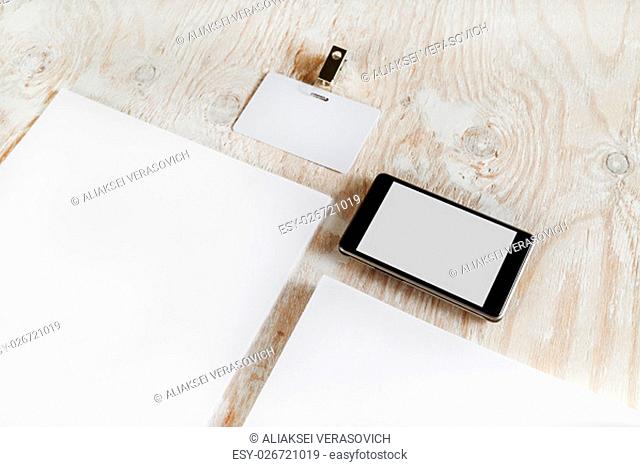 Fragment of blank stationery set. ID template on light wooden background. For design presentations and portfolios