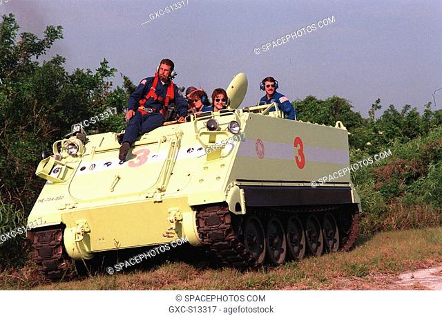 04/27/1999 --- At right, STS-96 Mission Specialist Tamara E. Jernigan Ph.D. practices driving the small armored personnel carrier that is part of emergency...