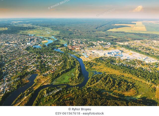 Aerial View Of Town Village Cityscape Skyline In Summer Sunny Morning. Daytime. Residential Houses, River Divides Small European City