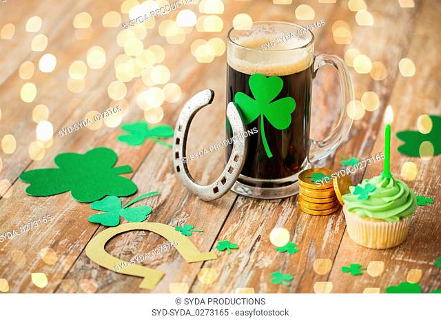 glass of beer, horseshoe, green cupcake and coins