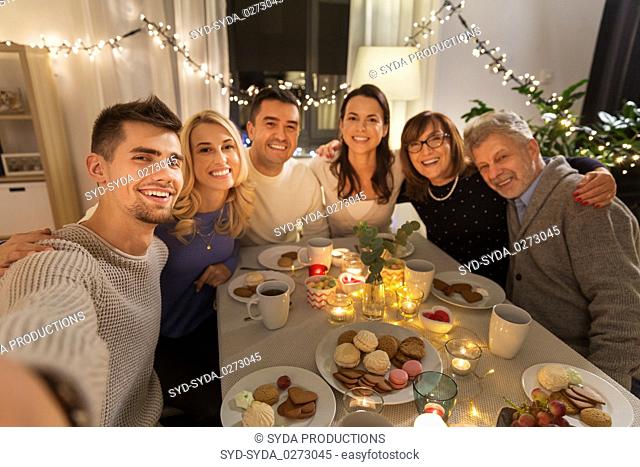 happy family taking selfie at tea party at home
