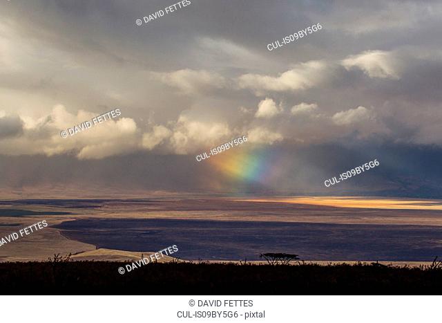 Landscape with storm clouds and rainbow light beams, Ngorongoro Crater, Ngorongoro Conservation Area, Tanzania