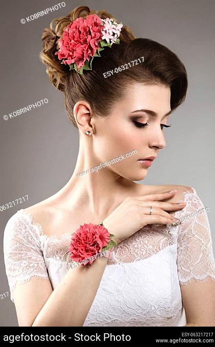 Portrait of a beautiful woman in the image of the bride with flowers in her hair. Picture taken in the studio on a black background