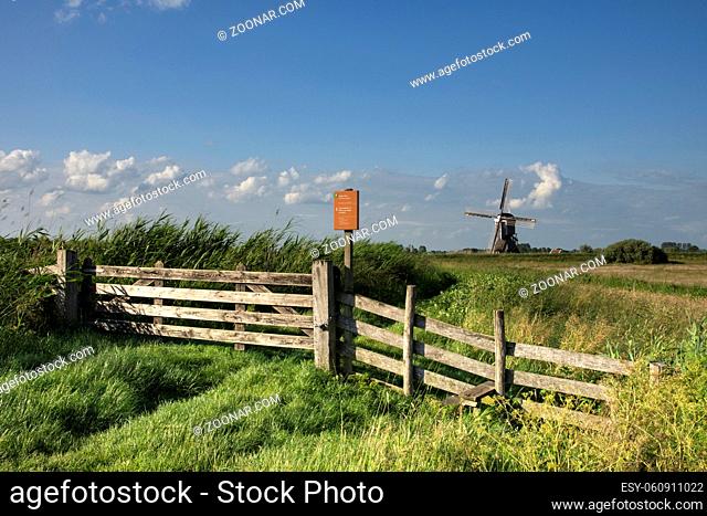 Nature area Donkse Laagten in the Dutch region Alblasserwaard with the windmill Broekmolen in the background