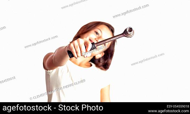 smiling little girl holding a socket wrench on white background