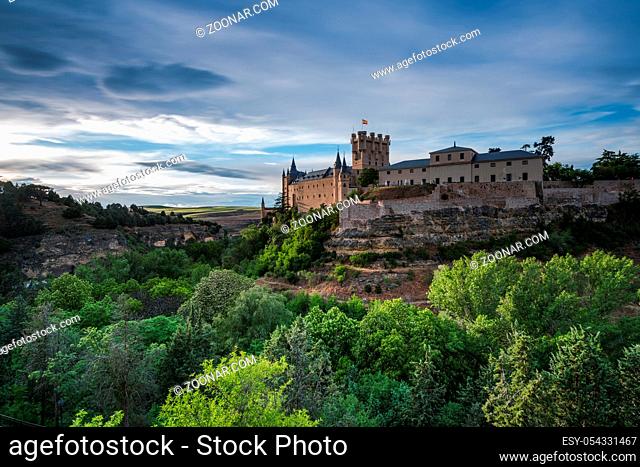 Alcazar in Segovia on hill top overlloking valley at cloudy day with sunny breaks