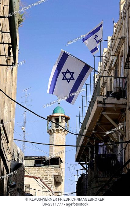 Minaret in the Muslim Quarter, with Israeli flags as a protest against Jews moving into the quarter driving out the Palestinian inhabitants, Old City, Jerusalem