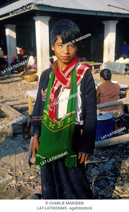 Young Hmong boy with green bag at market