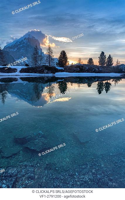 Europe, Italy, Veneto, Falzarego, Belluno. Morning view of the Tofana di Rozes reflected in the calm water of the Limedes lake, Dolomites