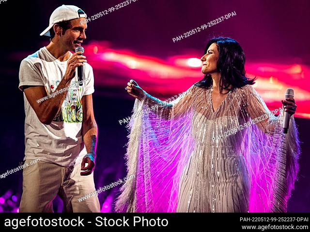 11 May 2022, Italy, Turin: Laura Pausini and Mika, the presenters and hosts, sing during the dress rehearsal for the second semi-final at the Eurovision Song...