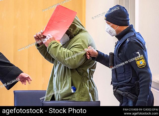 08 April 2021, Bavaria, Regensburg: The defendant stands in the hearing room at the regional court. The 37-year-old is alleged to have killed his six-year-old...