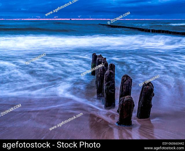 Old and weathered wooden wave breakers, Ustka, Baltic Sea, Poland