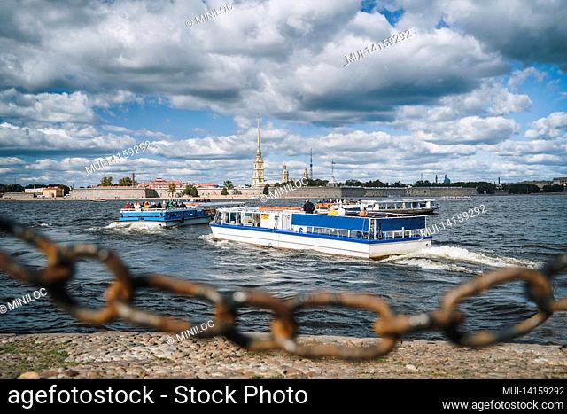 pleasure boat and the peter and paul fortress in background, st. petersburg, russia