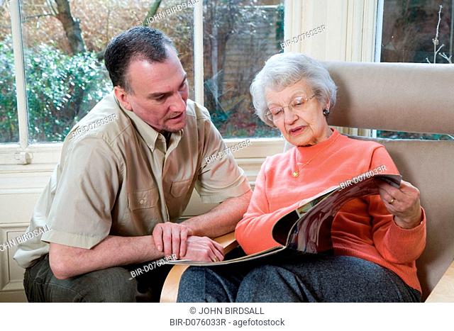 IndependentAge volunteer and older woman reading a magazine together