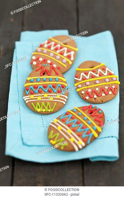 Decorated gingerbread eggs on a fabric napkin