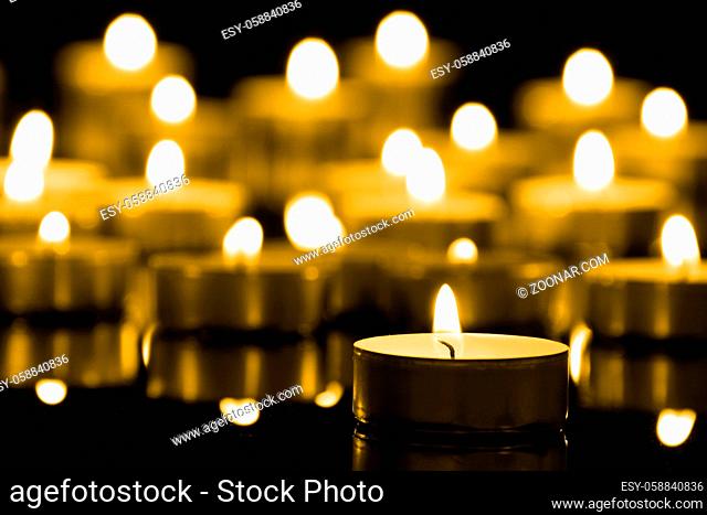 Candles on christmas night signifying hope. Gold. Background.With selective focus