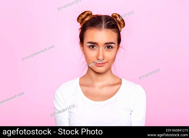 portrait of beautiful calm pensive woman on pink background