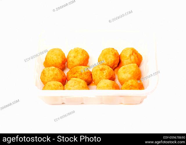Fried cheese balls on a package isolated on a white background