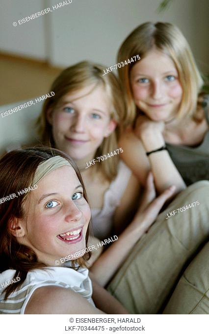 Three girls (12-15 years) smiling at camera