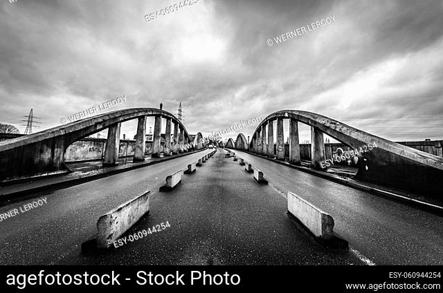 Schaerbeek, Brussels / Belgium: The dilapidated Albert Bridge with dark rainy sky in black and white