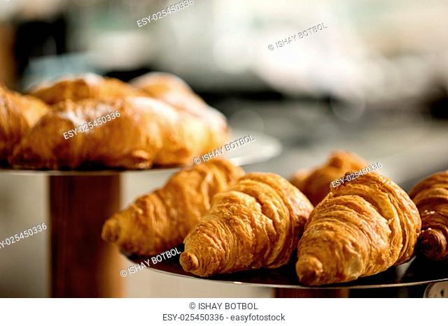 Fresh and tasty croissants displayed on plate
