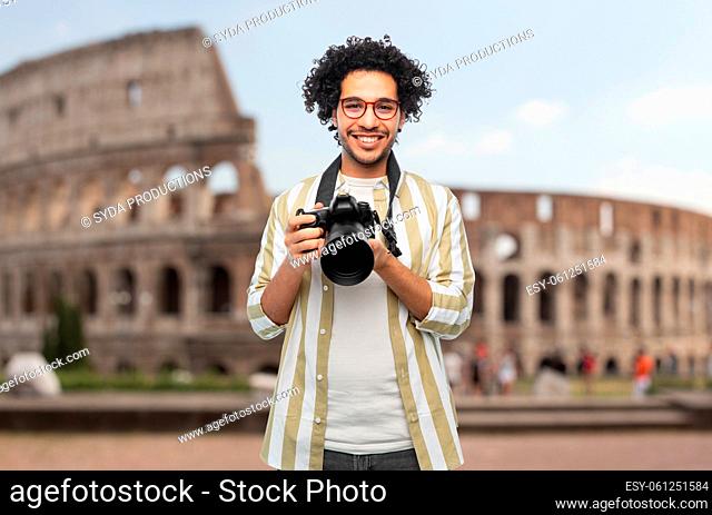 smiling man or photographer with camera in rome