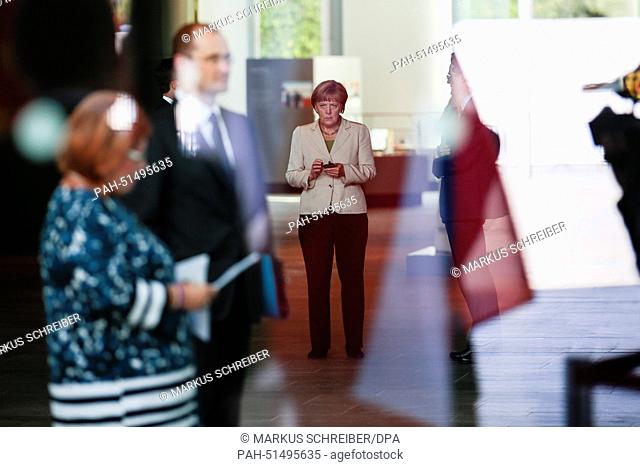 German Chancellor Angela Merkel uses her mobile phone as she waits for the arrival of the participants for the 'West Balkan Conference' at the chancellery in...