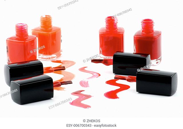 Four Bright Nail Varnishs and Spilled with Brushes isolated on white background