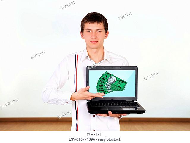 boy holding laptop with dollars on screen