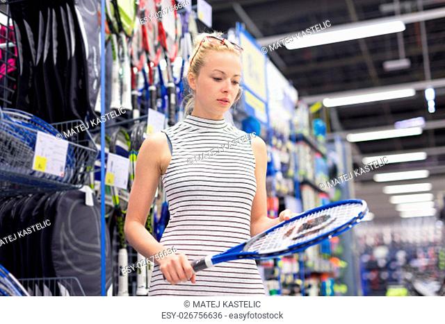 Beautiful caucasian woman shopping sports equipment in sportswear store