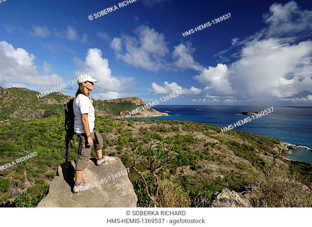 France, French West Indies, Saint Barthelemy, Gouverneur, youg lady hiking to the peak of the Gouverneur, looking at the morne Rouge