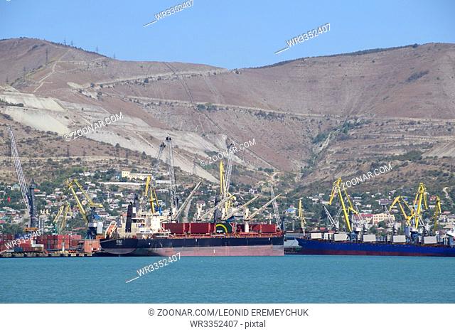 Novorossiysk, Russia - September 9, 2016: international seaports. Cargo port with port cranes. Sea bay and mountainous coast