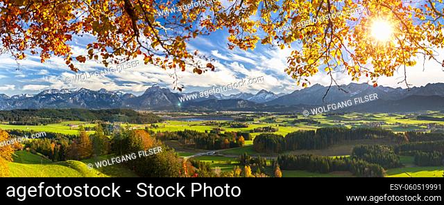 panoramic landscape with mountain range and sun on sky