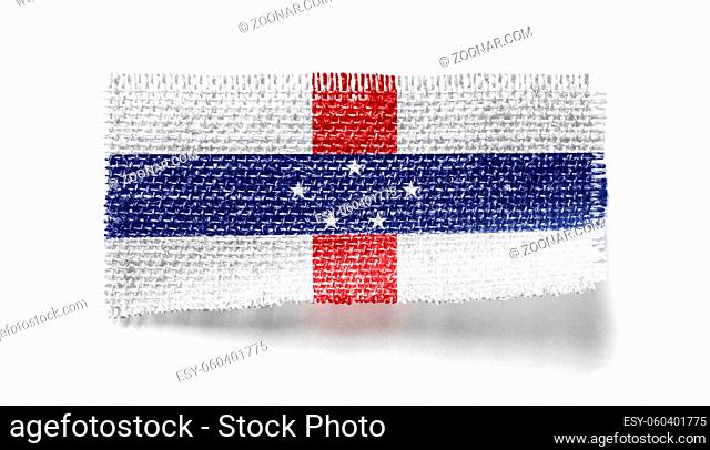 Netherlands Antilles flag on a piece of cloth on a white background