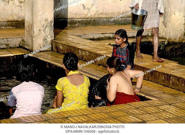 Women bathing in holy hot water spring on occasion of Tripuri Poornima at Ganeshpuri near Vajreshwari  ; Maharashtra ; India ; Asia