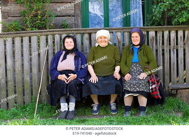 Three elderly ladies on a bench, Botiza, Maramures, Romania