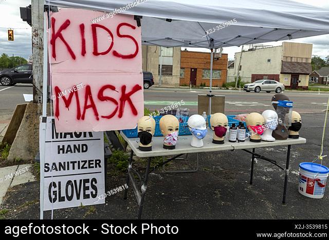 Detroit, Michigan, USA - 28 May 2020 - A street corner pop-up stand in a low-income neighborhood on the east side of Detroit sells masks, hand sanitizer