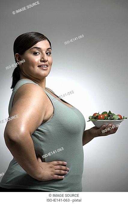 Woman holding bowl of salad