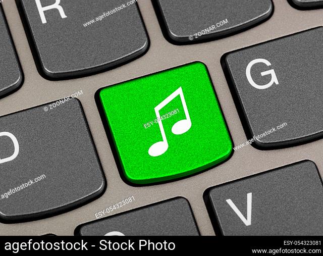 Computer keyboard with music key - technology background