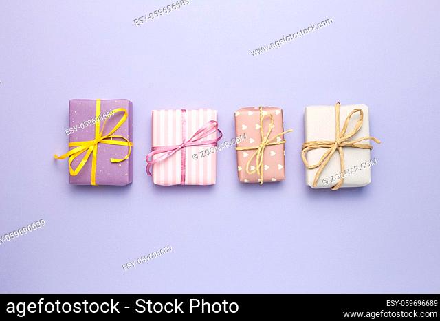 Purple gift boxes on purple background. flat lay, top view, copy space