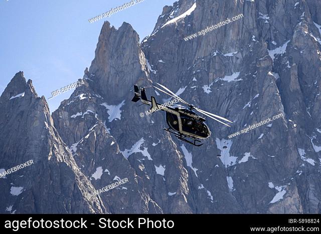 Helicopter in front of mountains, behind Aiguille du Midi, Alpine rescue, mountain rescue, Mont Blanc massif, Chamonix, Haute-Savoie, France, Europe