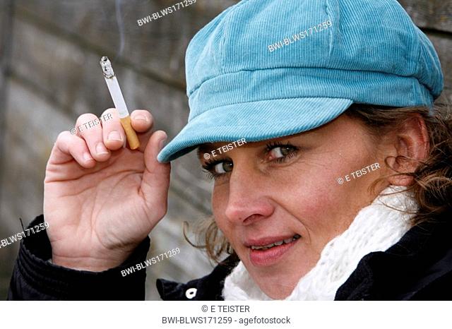 woman around fourty smoking a cigerette