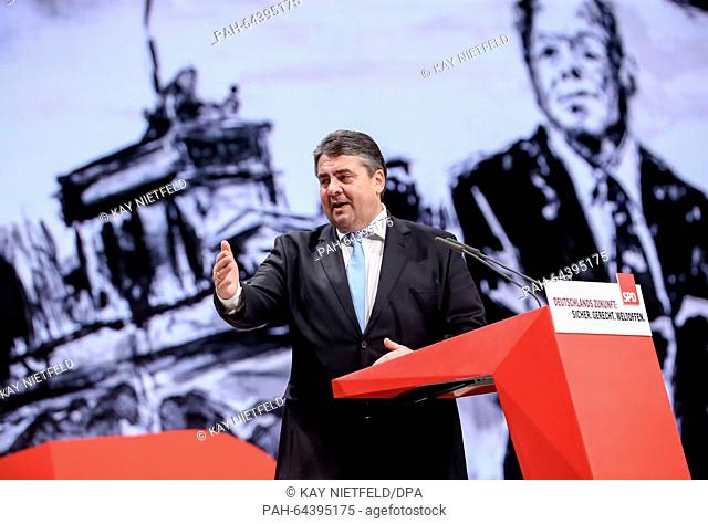 Sigmar Gabriel, SPD chairman and German economy minister, delivers a speech in front of an image of former German Chancellor Willy Brandt at the national...