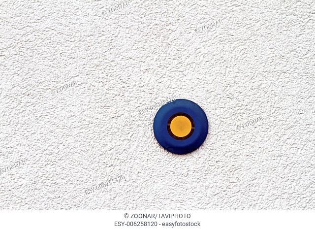 abstract view of blue and yellow button on mortar
