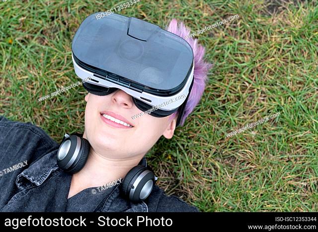 Young woman using VR helmet