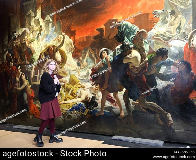 RUSSIA, ST PETERSBURG - DECEMBER 21, 2023: A woman stands by Karl Bryullov's history painting The Last Day of Pompeii at a press briefing on the start of the...