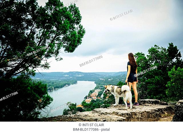 Caucasian woman and dog admiring scenic view