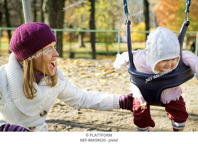 Mother and daughter in a playground Sweden