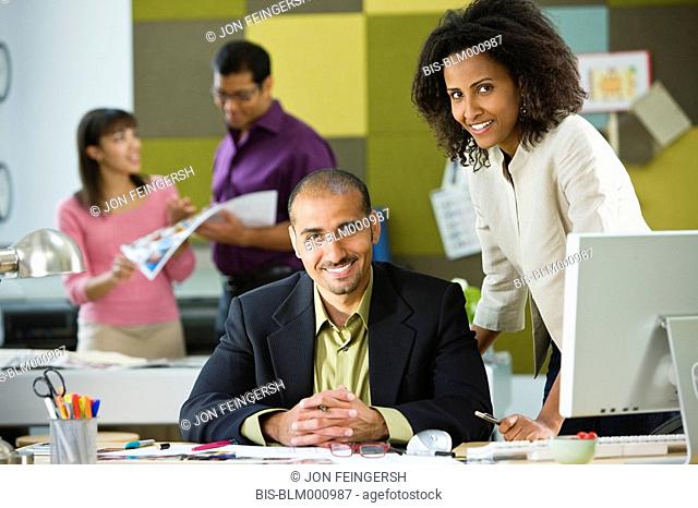 Business people standing at office desk