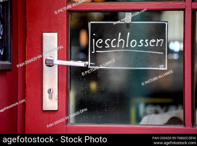 20 April 2020, Berlin: A sign on the entrance door of a pub with the inscription ""jeschlossen"" (closed) indicates that the locality has closed